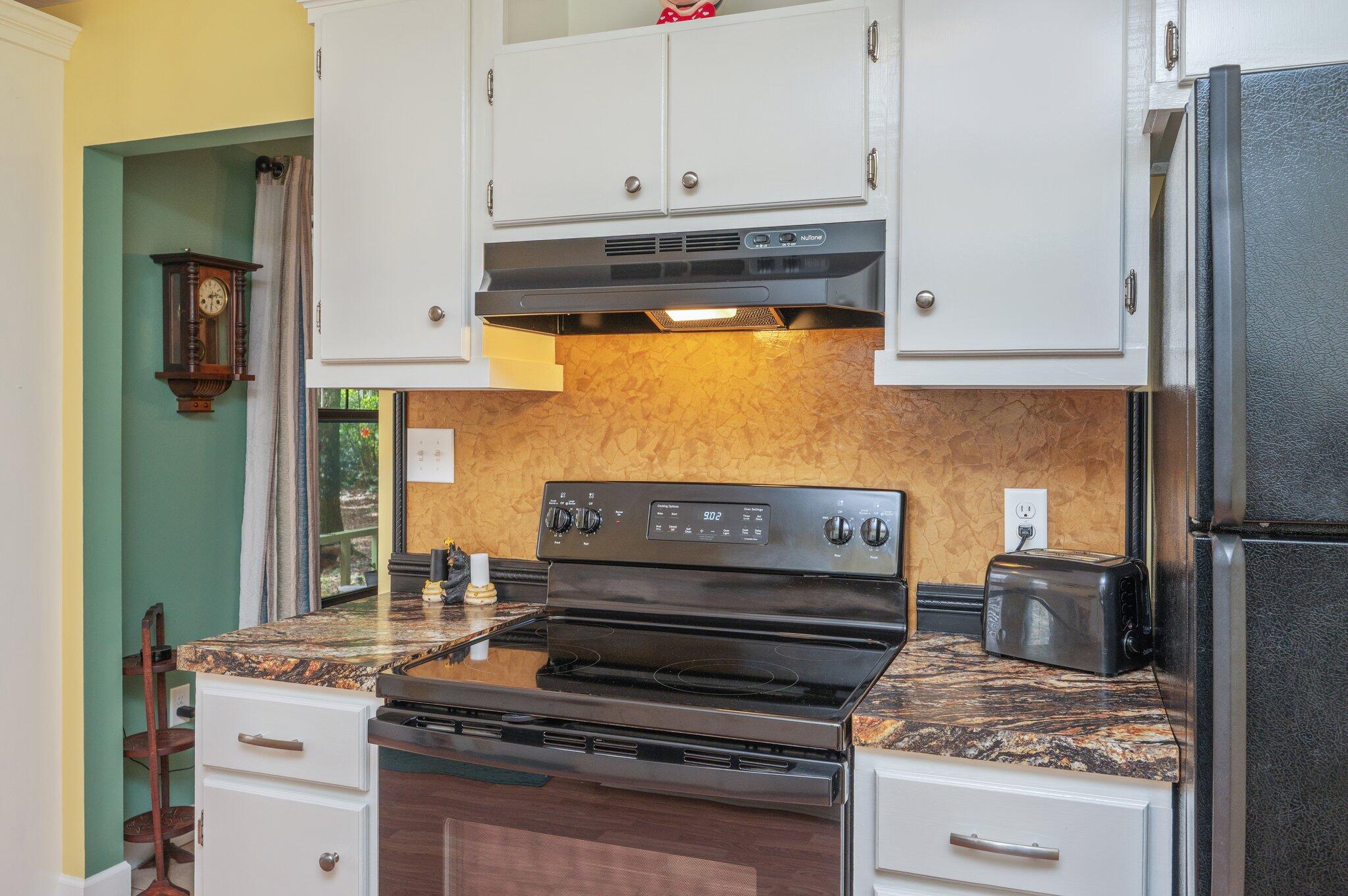 6256 Misty Lane Crestview, FL 32539 - Photo 12 of 39 a kitchen with a stove and a refrigerator