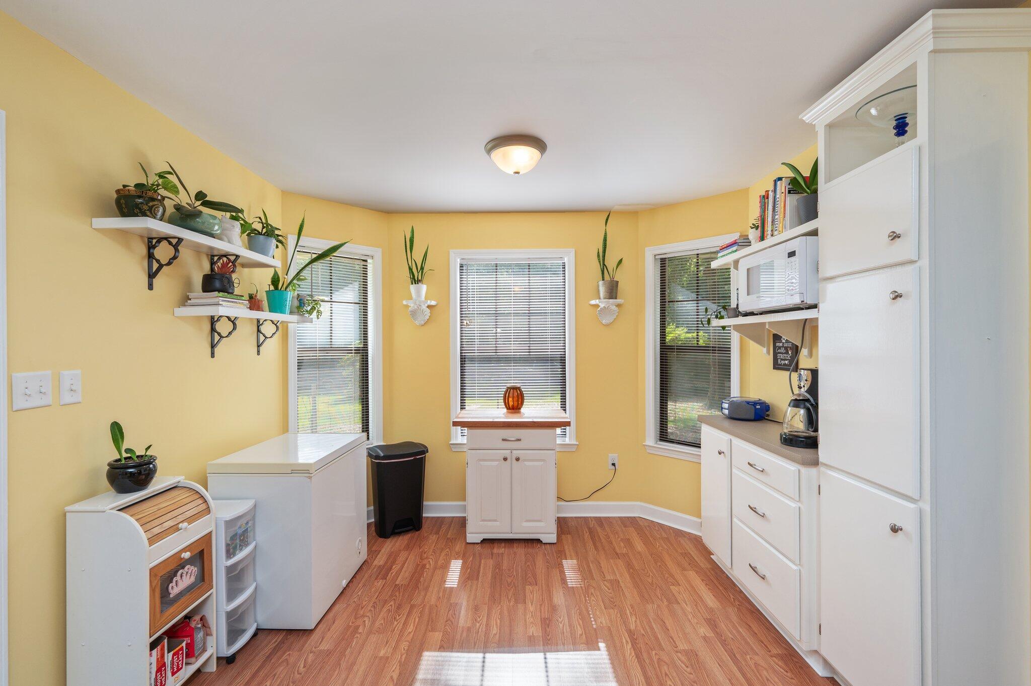 6256 Misty Lane Crestview, FL 32539 - Photo 13 of 39 a large white kitchen with a window wooden floor and stainless steel appliances