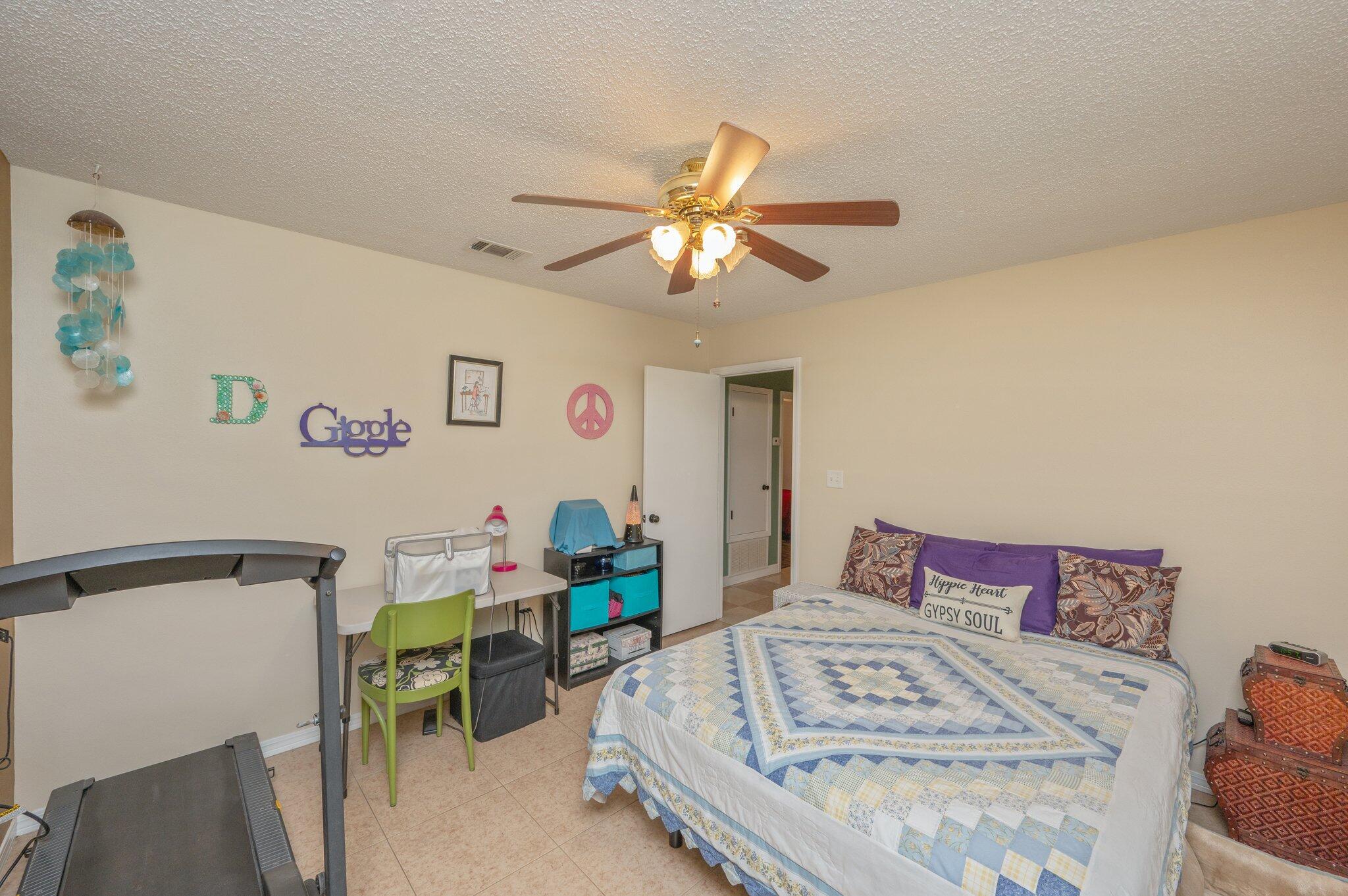 6256 Misty Lane Crestview, FL 32539 - Photo 15 of 39 a bedroom with a bed and a chandelier
