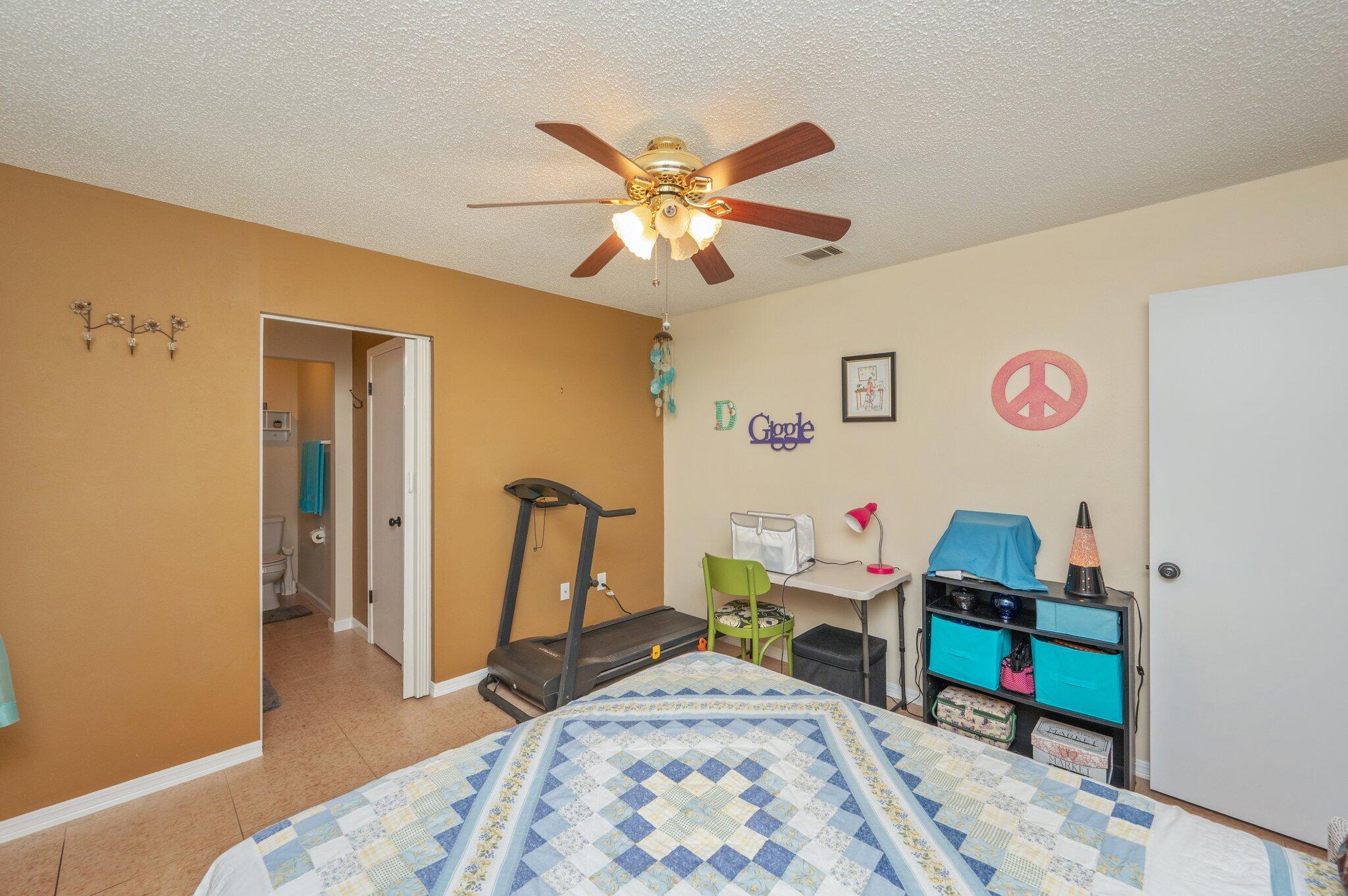 6256 Misty Lane Crestview, FL 32539 - Photo 16 of 39 a bedroom with a bed and a chandelier