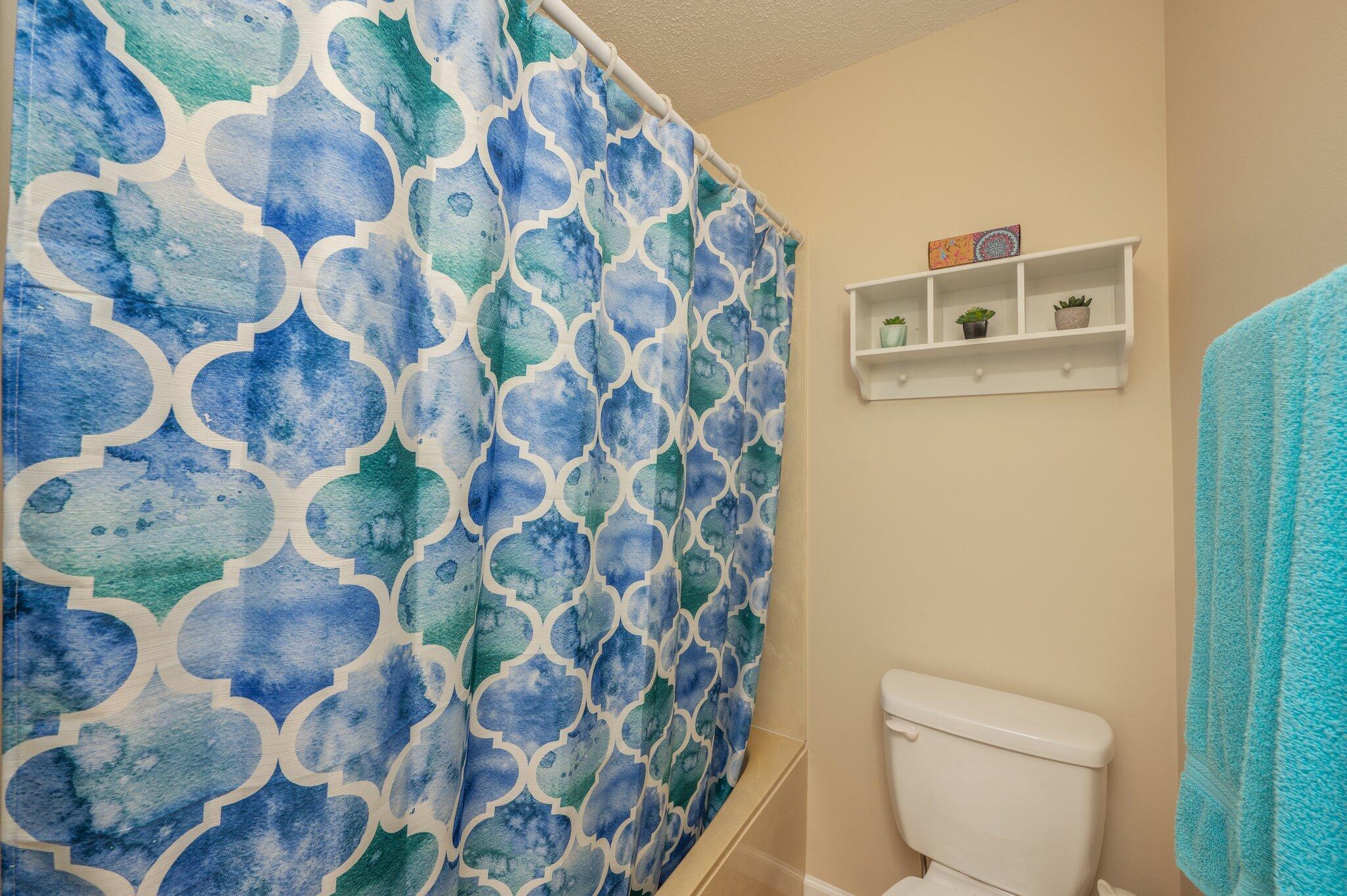 6256 Misty Lane Crestview, FL 32539 - Photo 18 of 39 a bathroom with a toilet and a shower curtain