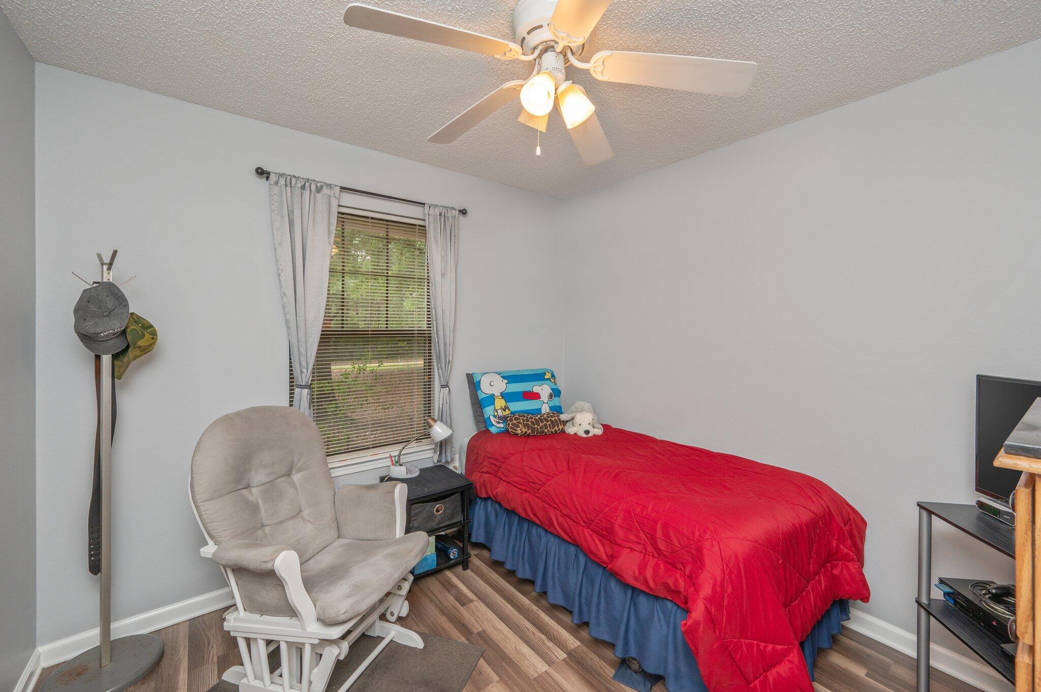 6256 Misty Lane Crestview, FL 32539 - Photo 19 of 39 a bedroom with a bed and a chandelier