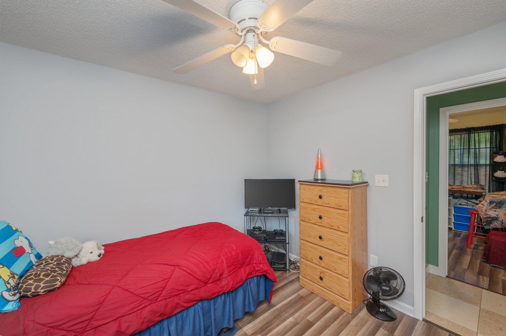 6256 Misty Lane Crestview, FL 32539 - Photo 20 of 39 a bedroom with a bed and a dresser in it