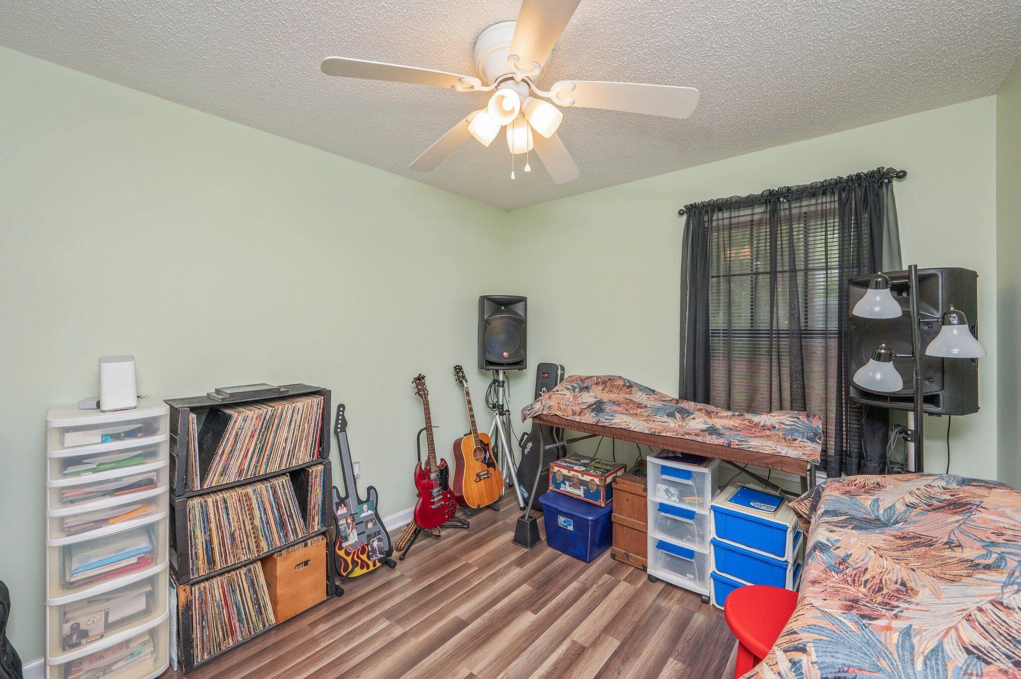 6256 Misty Lane Crestview, FL 32539 - Photo 24 of 39 a bedroom with a bed and wooden floor