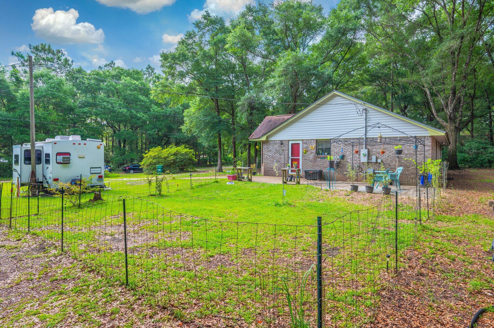 6256 Misty Lane Crestview, FL 32539 - Photo 29 of 39 a backyard of a house with table and chairs