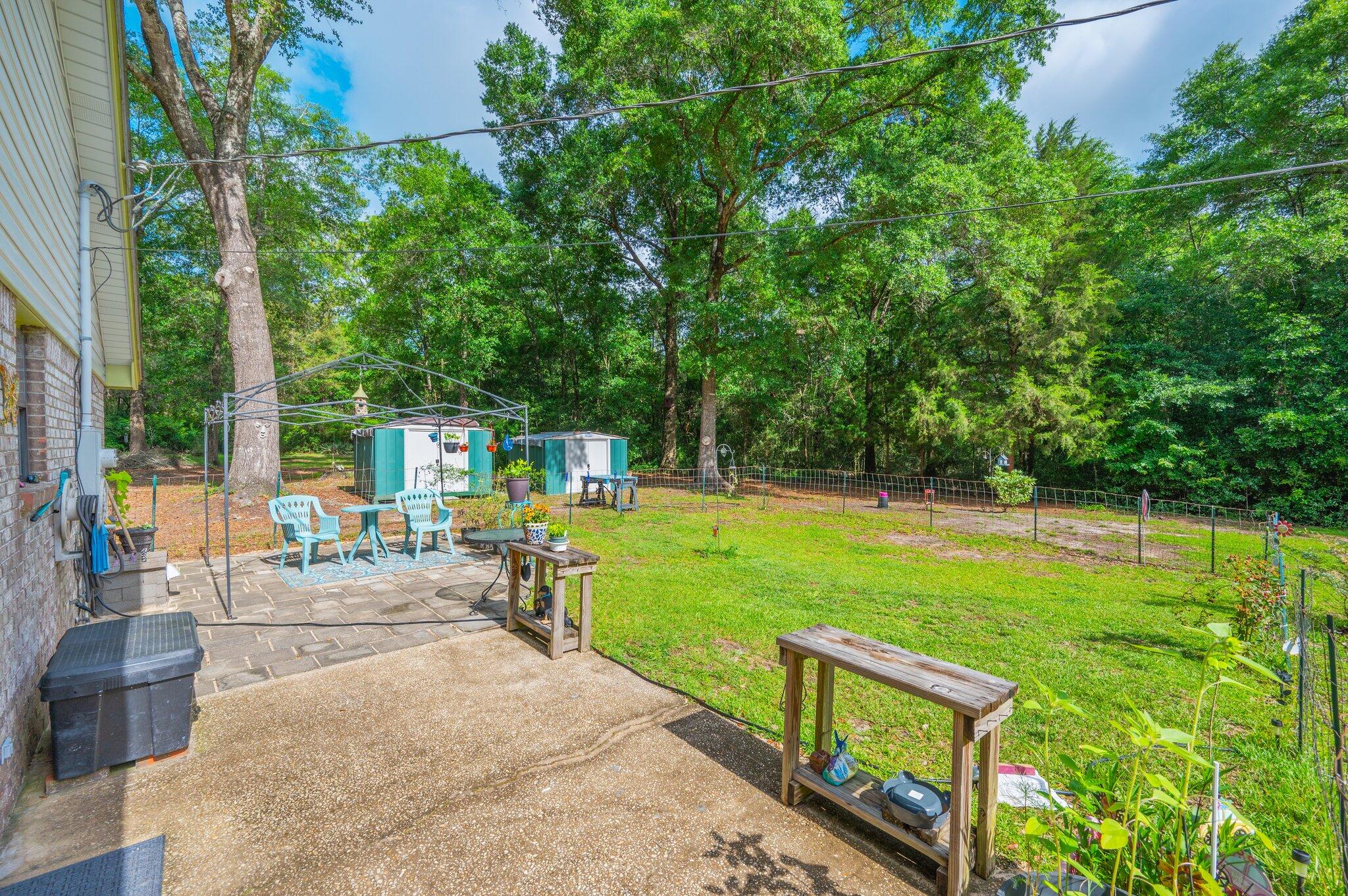 6256 Misty Lane Crestview, FL 32539 - Photo 30 of 39 a view of a garden with lawn chairs