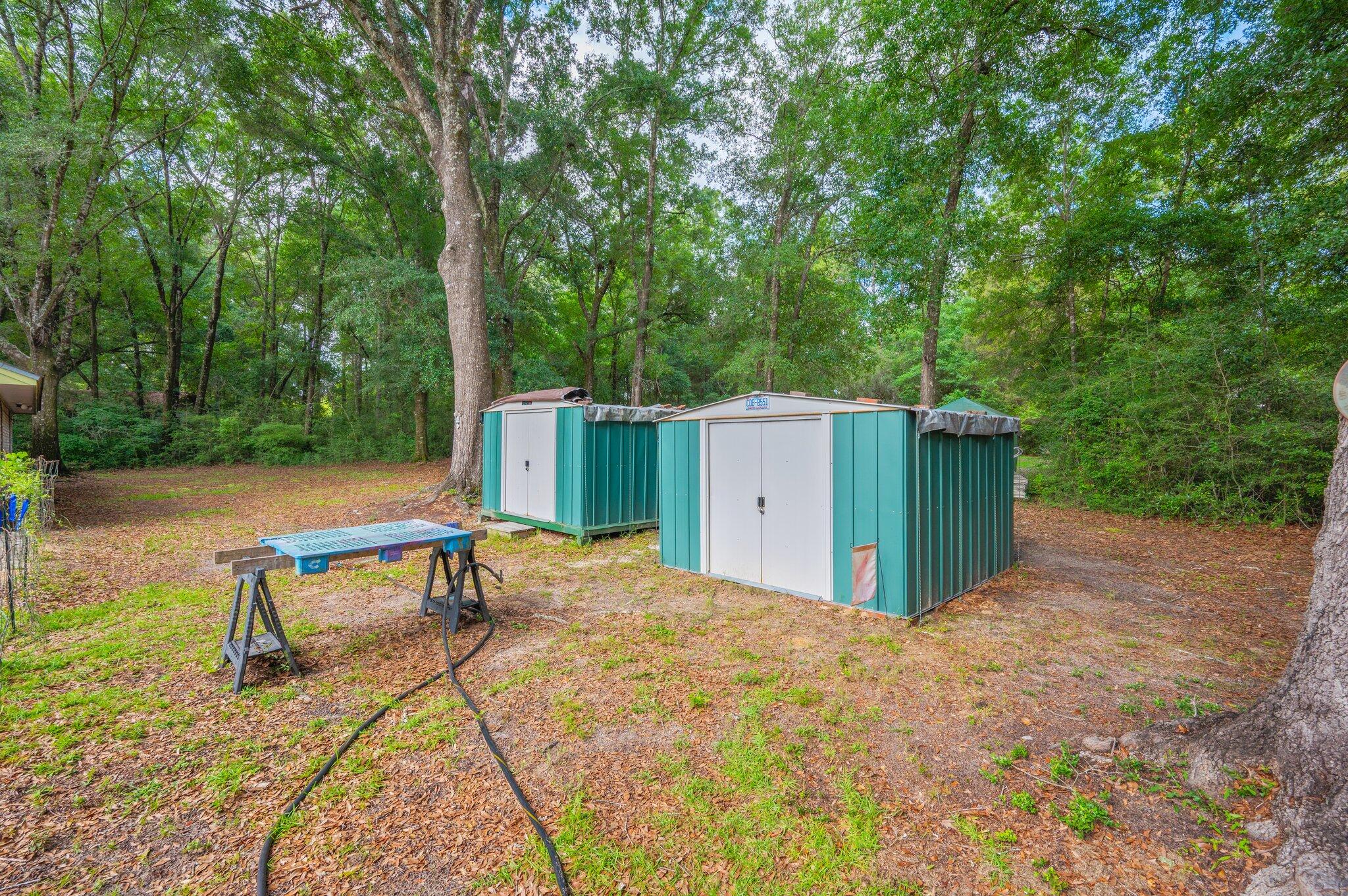 6256 Misty Lane Crestview, FL 32539 - Photo 31 of 39 a backyard of a house with table and chairs