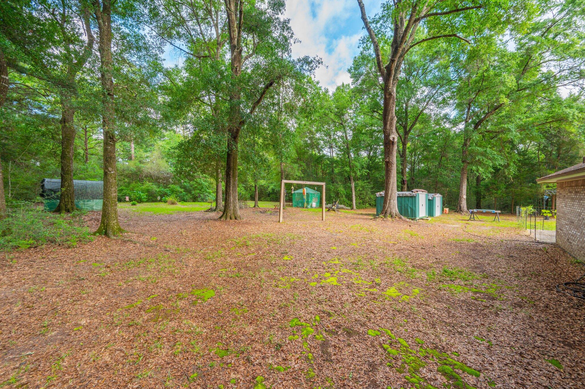 6256 Misty Lane Crestview, FL 32539 - Photo 34 of 39 a view of a field with trees in front of it