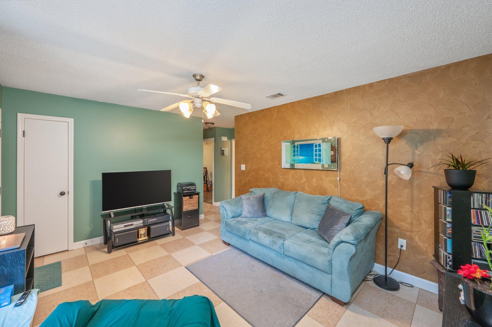 6256 Misty Lane Crestview, FL 32539 - Photo 6 of 39 a living room with furniture and a flat screen tv