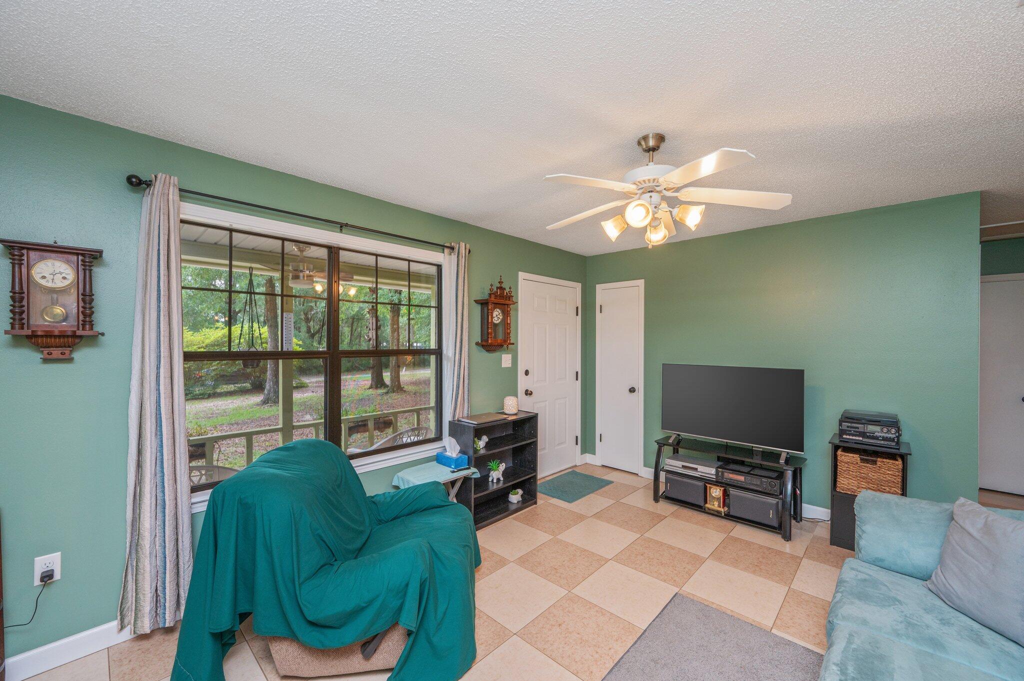 6256 Misty Lane Crestview, FL 32539 - Photo 8 of 39 a living room with furniture and a flat screen tv