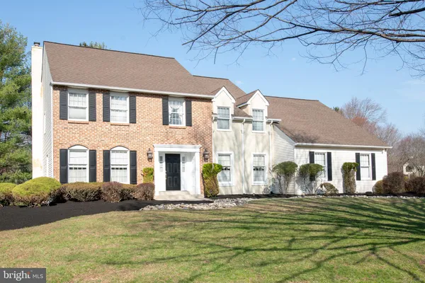 a front view of house with a garden