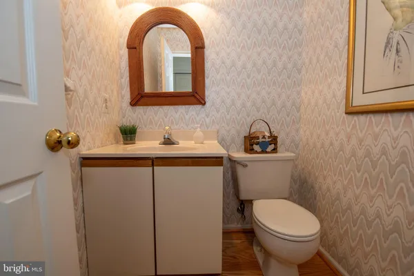 a bathroom with a sink toilet and mirror