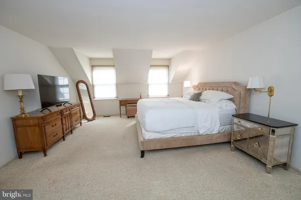 a bedroom with a bed and couch
