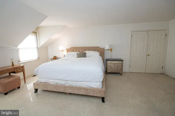a bedroom with a bed and a lamp