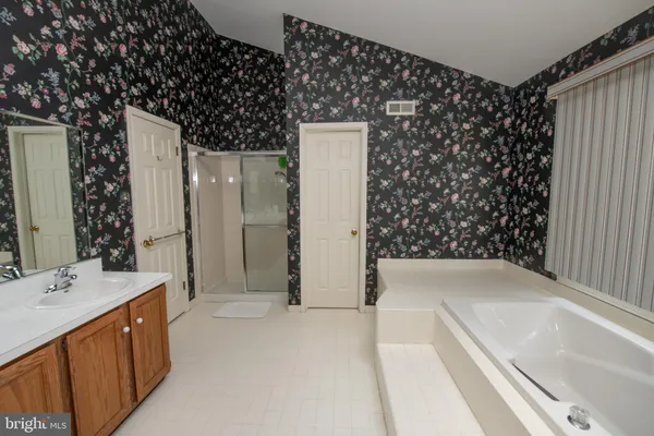 a bathroom with a double vanity sink and mirror