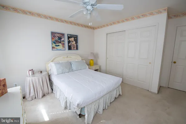 a bedroom with a bed and a potted plant