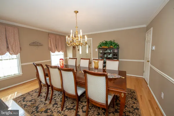 a view of a dining room with furniture and chandelier