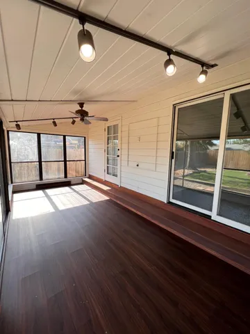 a view of a balcony with wooden floor