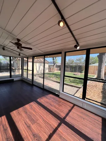a view of a room with wooden floor