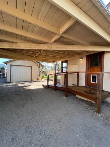 a view of a backyard with large trees