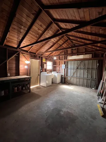 a view of empty room with wooden walls