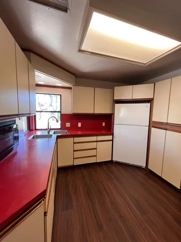 a room with wooden floor and furniture