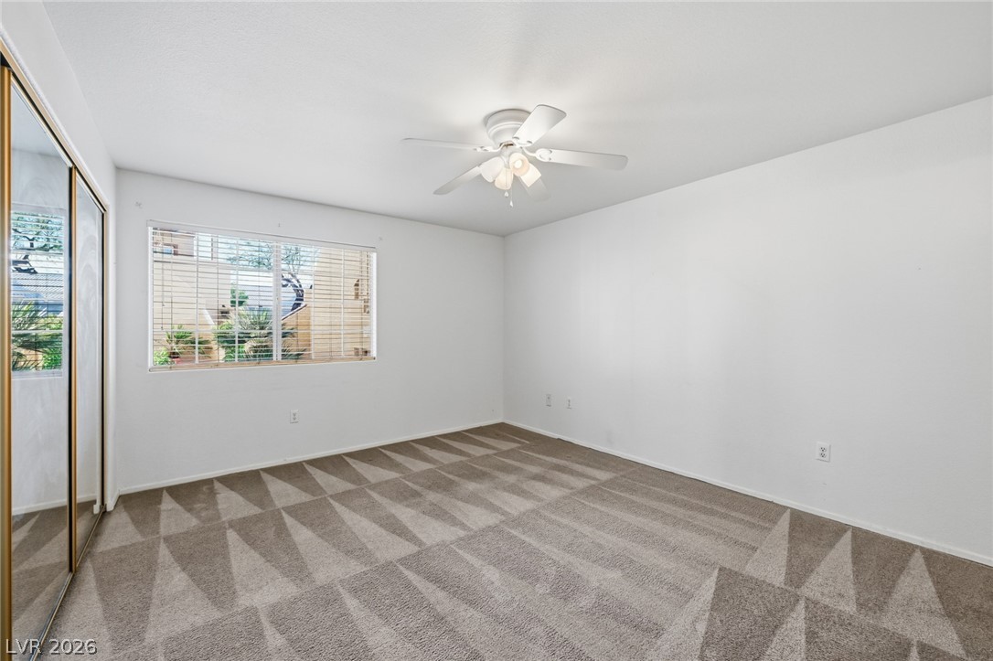 1851 Hillpointe Road, Unit 1311 Henderson, NV 89074 - Photo 19 of 47 Empty room featuring a ceiling fan and light colored carpet