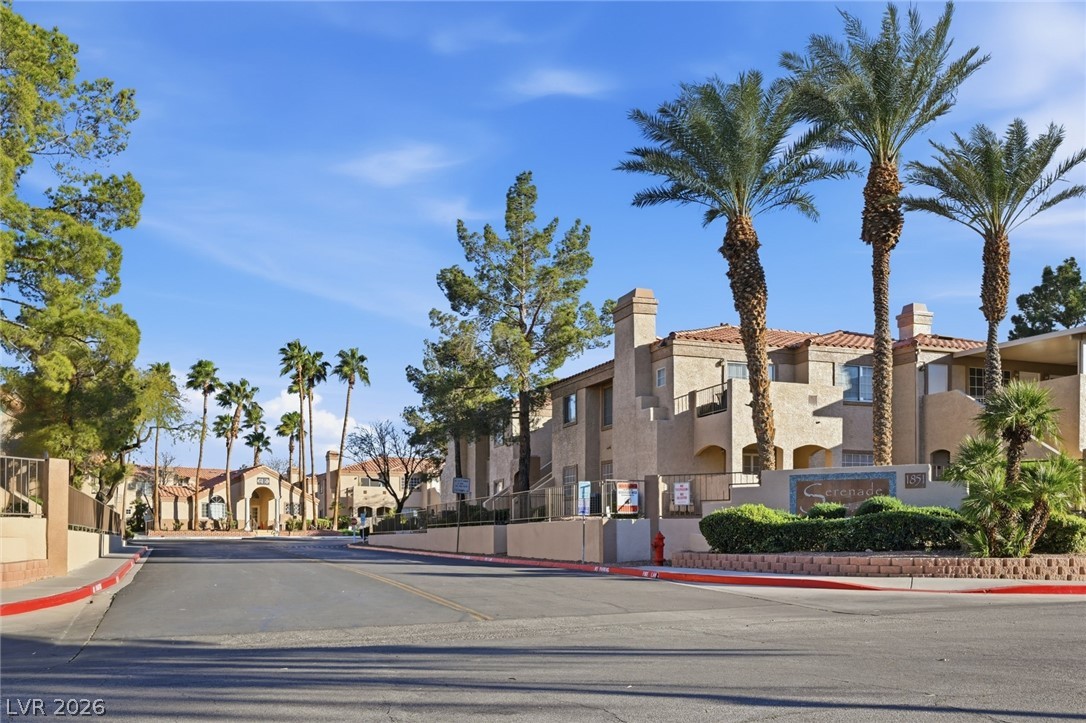 1851 Hillpointe Road, Unit 1311 Henderson, NV 89074 - Photo 30 of 47 View of asphalt road with curbs, sidewalks, and a residential view