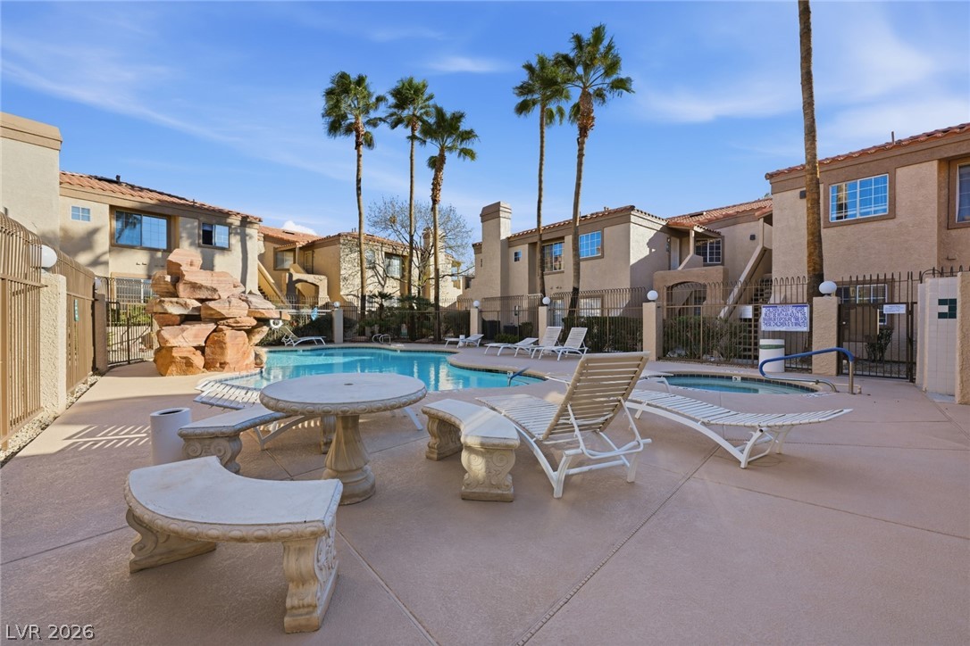 1851 Hillpointe Road, Unit 1311 Henderson, NV 89074 - Photo 34 of 47 Community pool featuring a community hot tub, a patio area, and a residential view