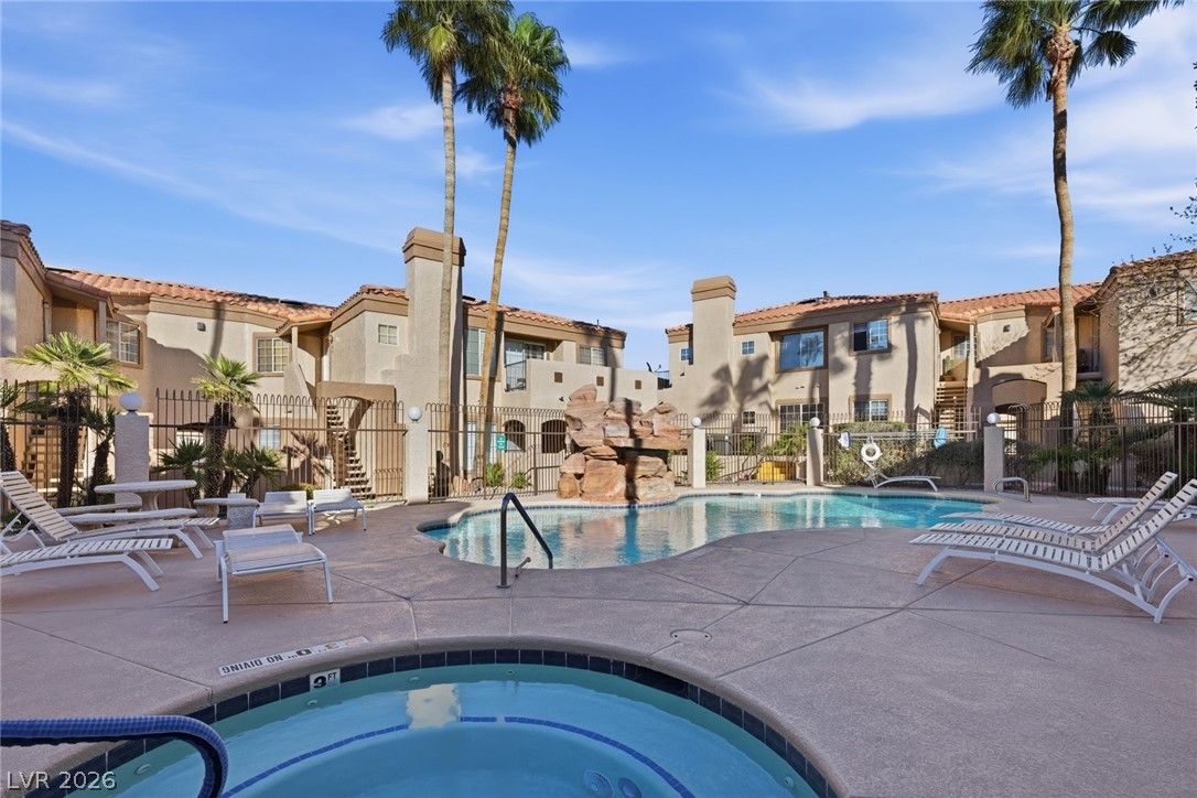 1851 Hillpointe Road, Unit 1311 Henderson, NV 89074 - Photo 36 of 47 Community pool with a patio area, a hot tub, and a residential view
