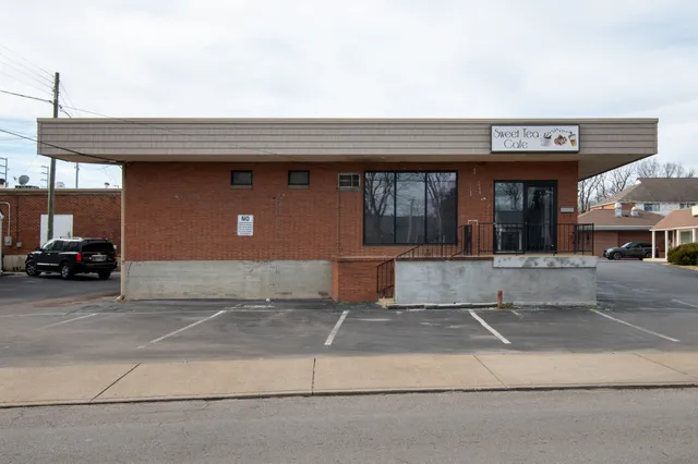 a front view of a building with parking space