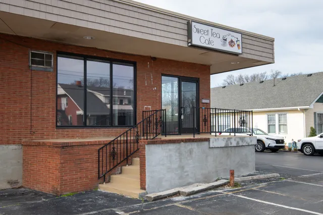 a view of a building with car parked