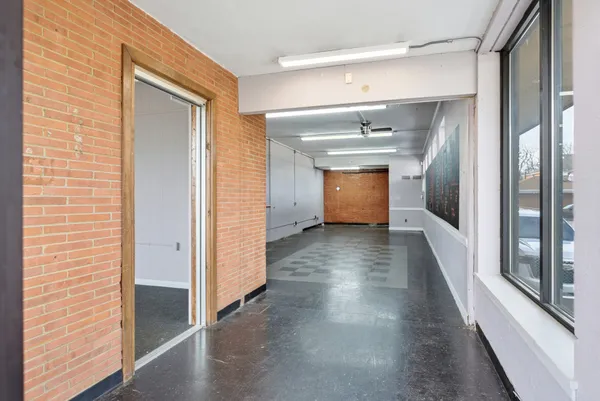 a view of a hallway view with wooden floor and staircase