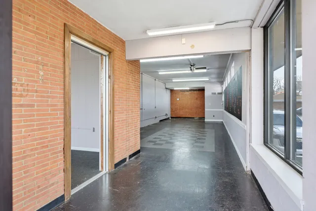 a view of a hallway view with wooden floor and staircase