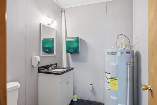a picture of a bathroom with sink and mirror