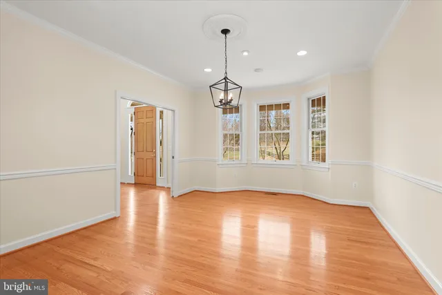 a view of a dining room with furniture wooden floor and chandelier
