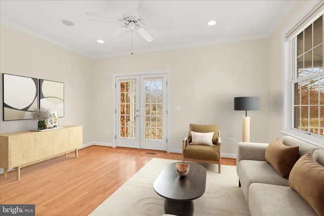 a view of empty room with wooden floor and window