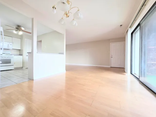 a kitchen with granite countertop cabinets and white appliances