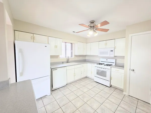 a kitchen with a refrigerator a sink and cabinets