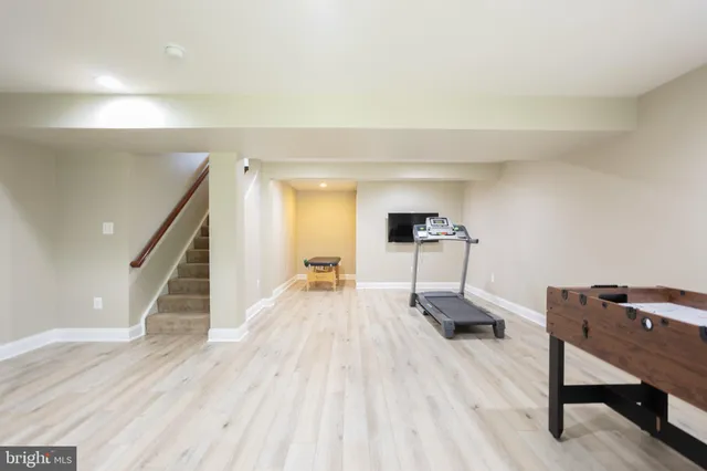 a view of a room with wooden floor and stairs