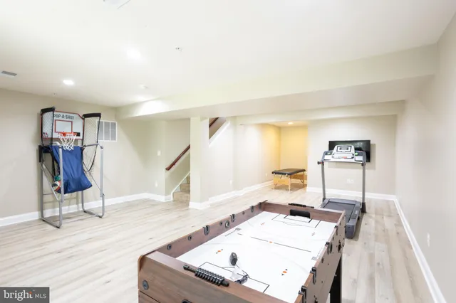 a living room with white furniture and wooden floor