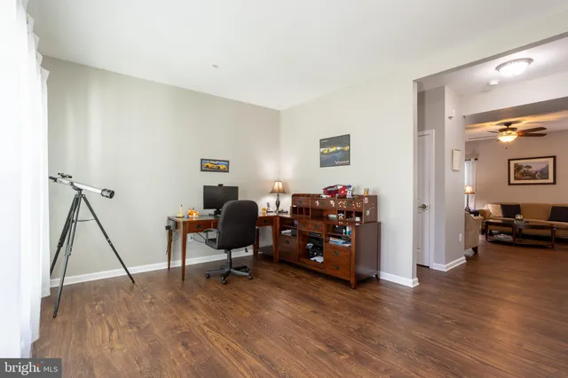 a view of a workspace with furniture and a bedroom