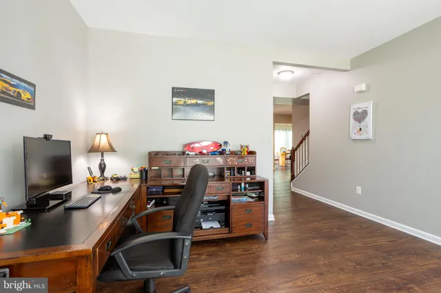 a view of a workspace with furniture and a flat screen tv