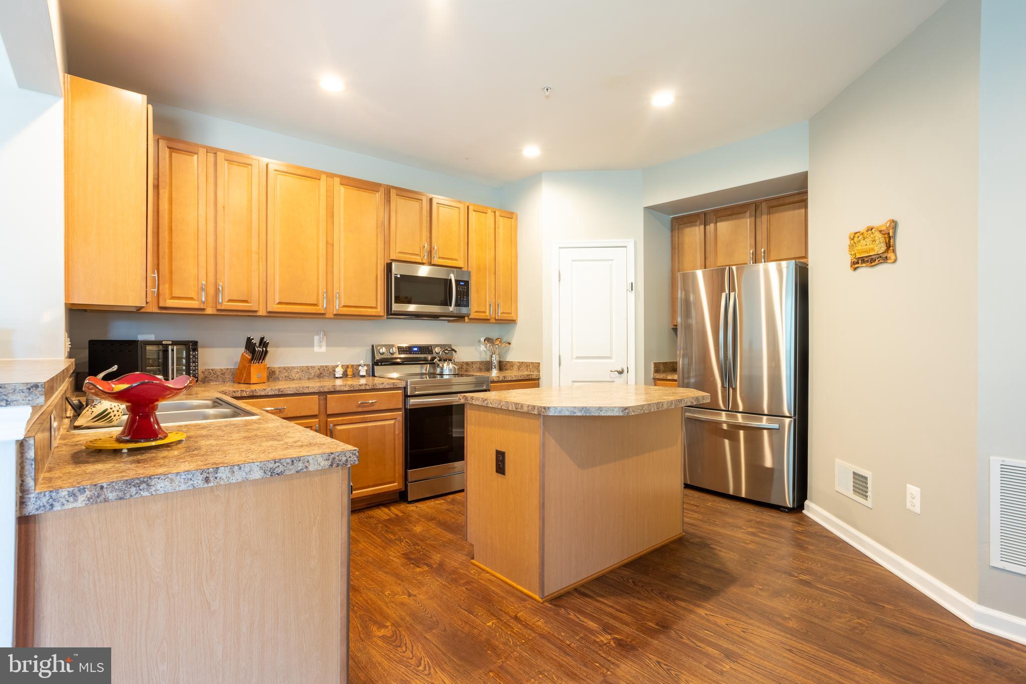 153 Cool Springs Road North East, MD 21901 - Photo 21 of 47 a kitchen with stainless steel appliances granite countertop a refrigerator a stove top oven a sink and dishwasher with wooden floor