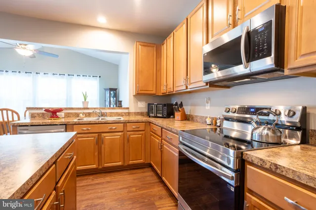 a kitchen with a stove top oven sink and cabinets