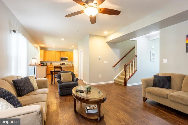 a living room with furniture and a dining table
