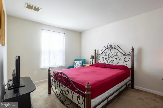 a bed room with a bed and a tv