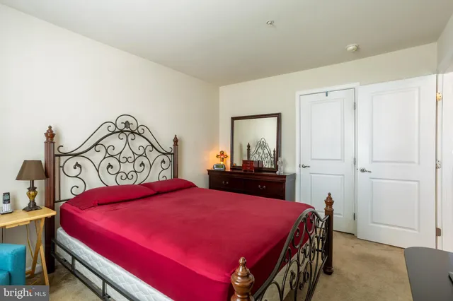 a bedroom with a bed and a dresser