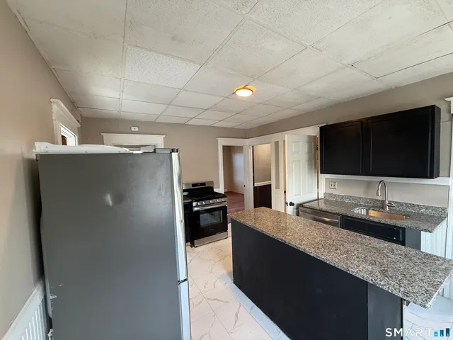 a kitchen with counter top space and stainless steel appliances