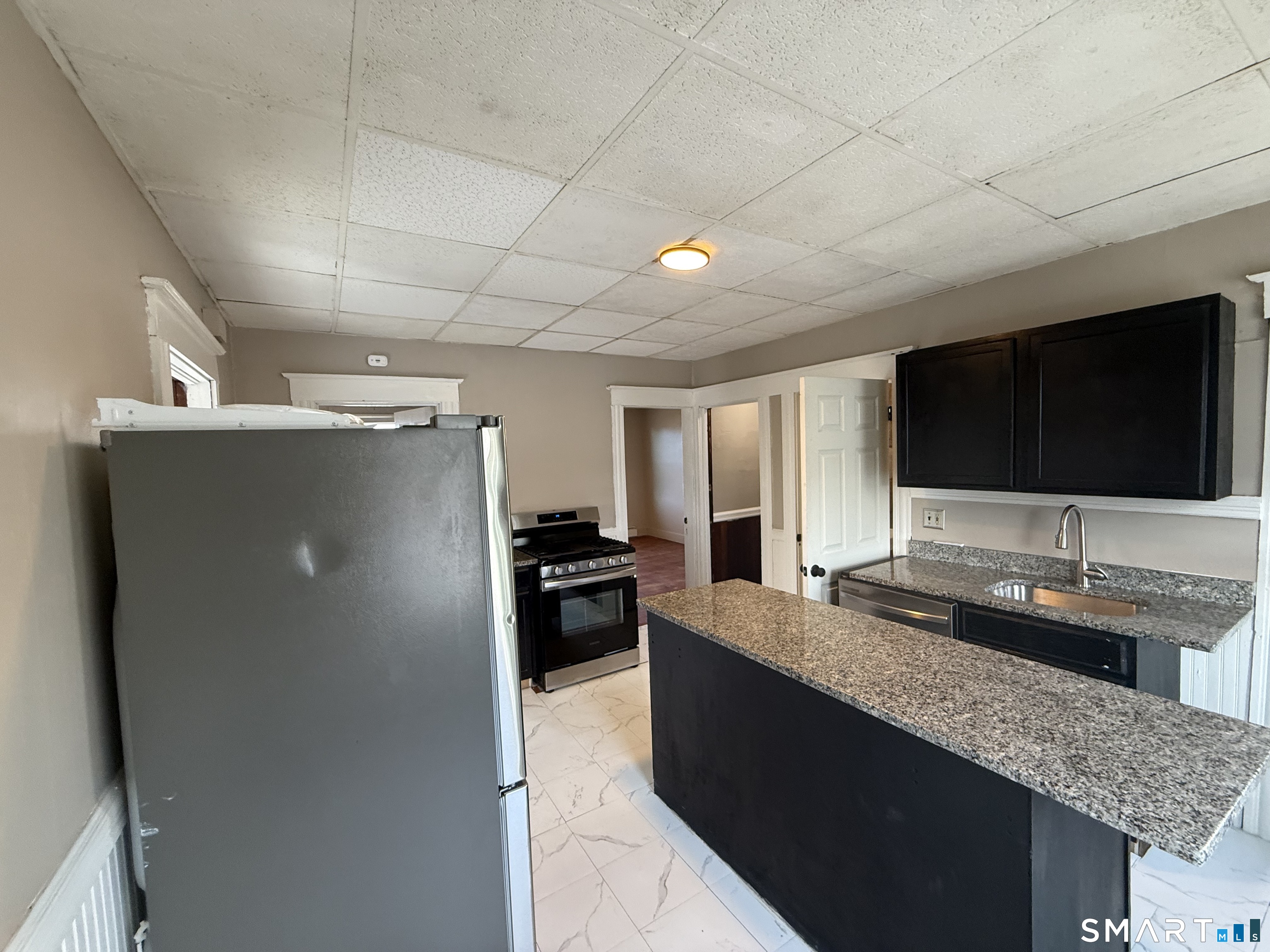 154 Daly Avenue, Unit 3 New Britain, CT 06051 - Photo 13 of 25 a kitchen with counter top space and stainless steel appliances